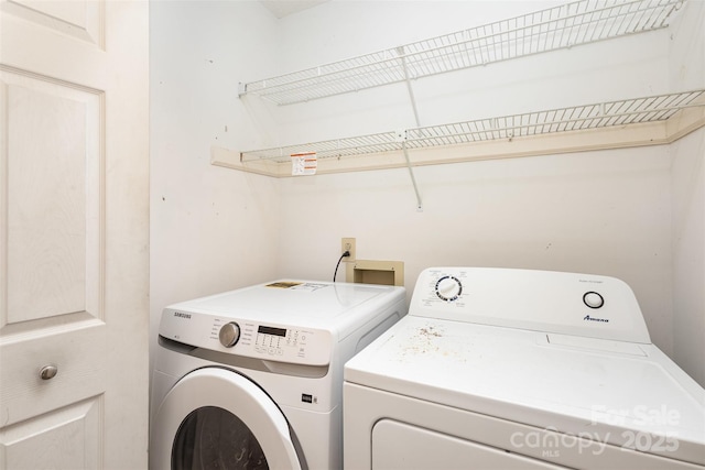 clothes washing area featuring laundry area and washing machine and clothes dryer