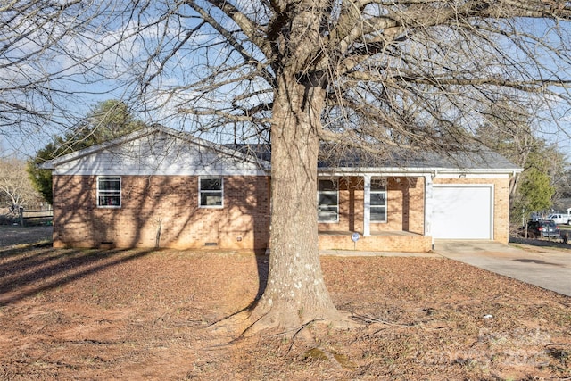 ranch-style house with crawl space, driveway, an attached garage, and brick siding