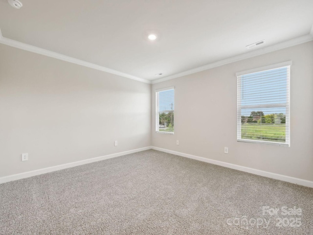 carpeted empty room featuring ornamental molding, recessed lighting, visible vents, and baseboards