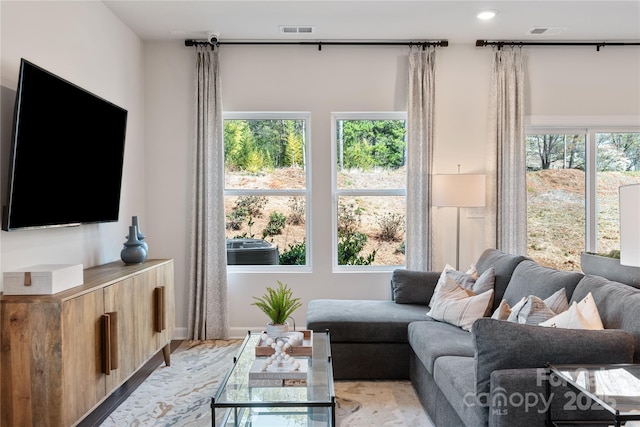 living room with a healthy amount of sunlight and visible vents