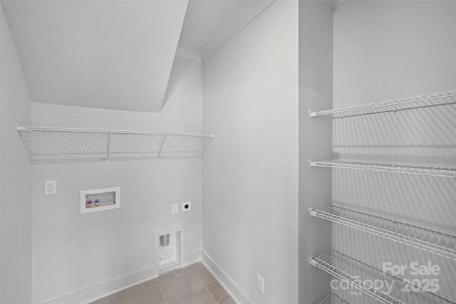 laundry room with washer hookup, light tile patterned flooring, electric dryer hookup, laundry area, and baseboards