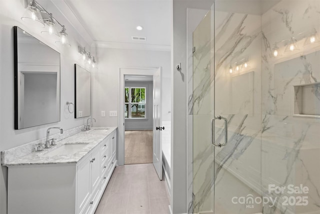 full bath featuring visible vents, a sink, a marble finish shower, and double vanity