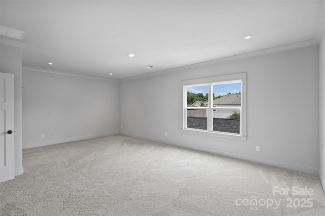 spare room featuring light carpet, ornamental molding, baseboards, and recessed lighting