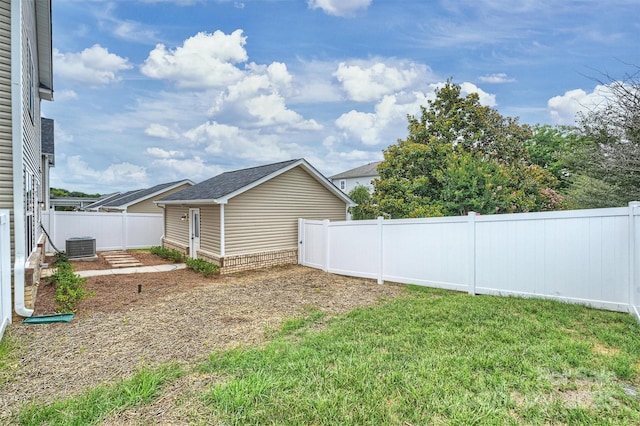 view of yard featuring a fenced backyard and central AC unit