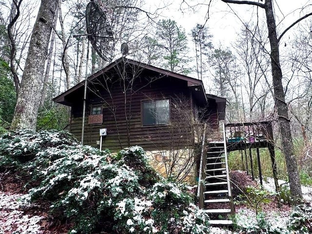 view of side of home featuring stairway