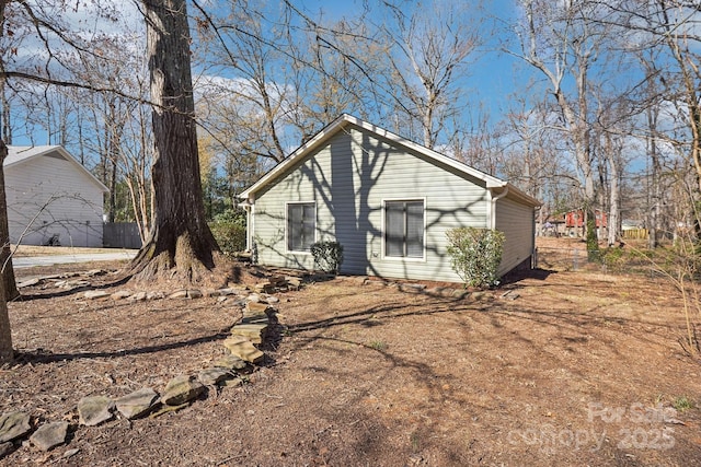 view of side of property with fence