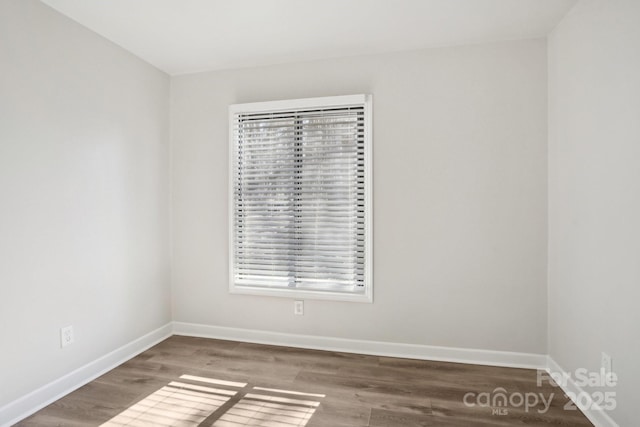 unfurnished room with wood finished floors and baseboards