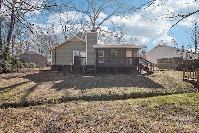 back of property featuring central air condition unit, stairway, a chimney, and fence