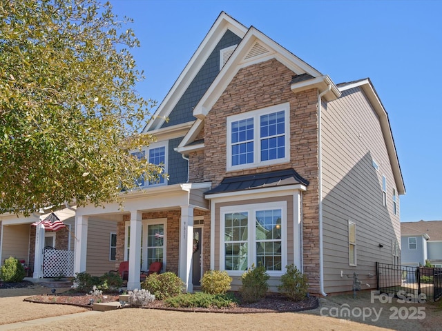 view of front of home with stone siding and a porch