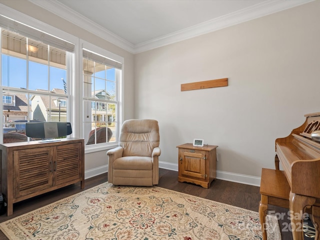 sitting room with baseboards, crown molding, and wood finished floors