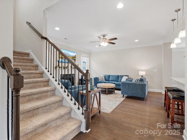 living room with baseboards, ornamental molding, dark wood-type flooring, and recessed lighting