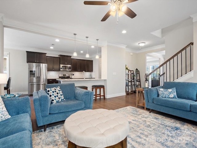 living room with baseboards, dark wood-style floors, ornamental molding, stairs, and recessed lighting