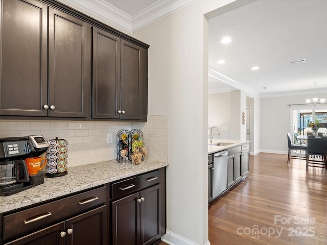 kitchen featuring ornamental molding, a sink, dark brown cabinetry, wood finished floors, and dishwasher