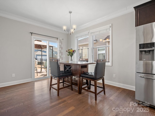 dining area featuring baseboards, ornamental molding, a chandelier, and dark wood-style flooring