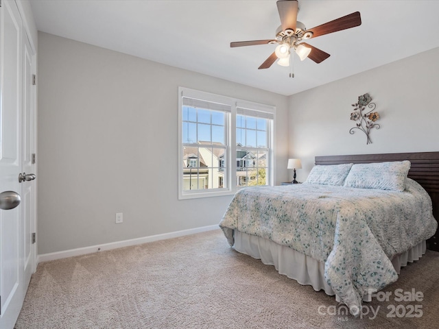 carpeted bedroom with ceiling fan and baseboards