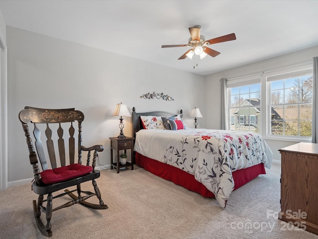 carpeted bedroom with ceiling fan and baseboards