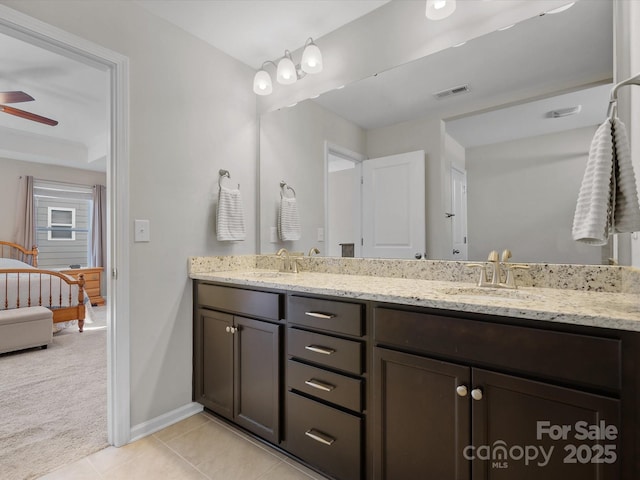 full bath featuring double vanity, visible vents, a ceiling fan, tile patterned flooring, and a sink