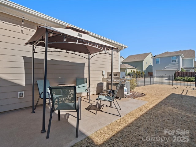 view of patio / terrace featuring a residential view, fence, area for grilling, and a gazebo