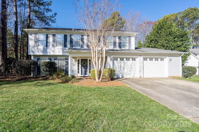 view of front of house featuring an attached garage, concrete driveway, and a front yard