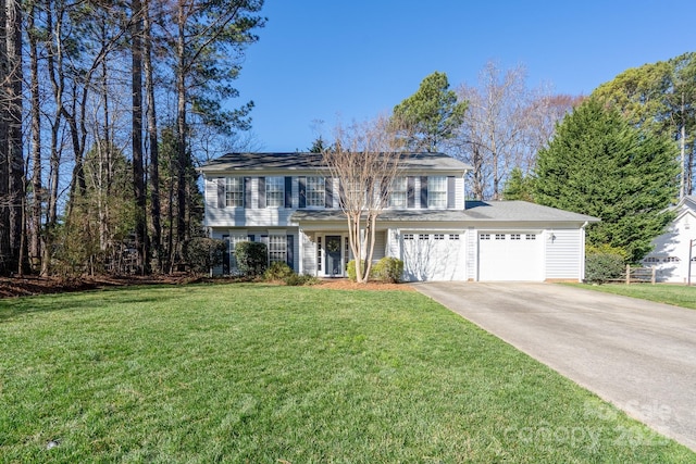 colonial house featuring a garage, concrete driveway, and a front yard