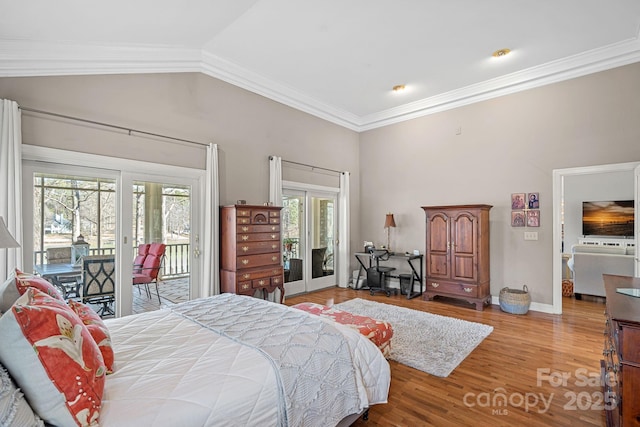 bedroom with access to exterior, crown molding, lofted ceiling, wood finished floors, and baseboards