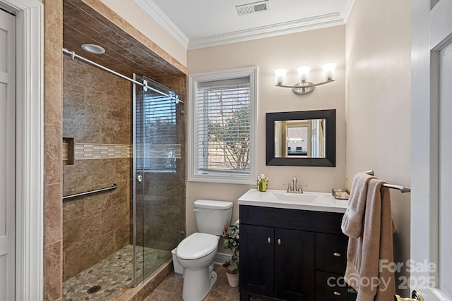 bathroom featuring toilet, ornamental molding, a stall shower, and visible vents