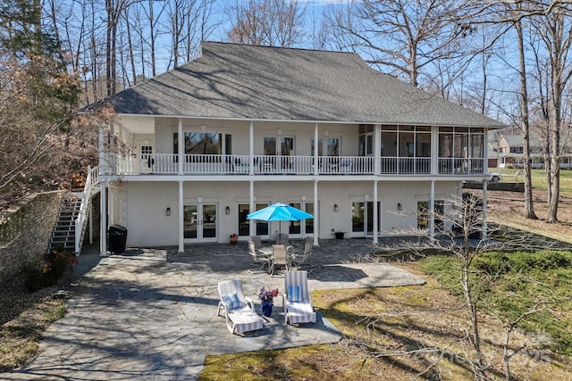 back of house featuring a patio, french doors, stairway, and roof with shingles