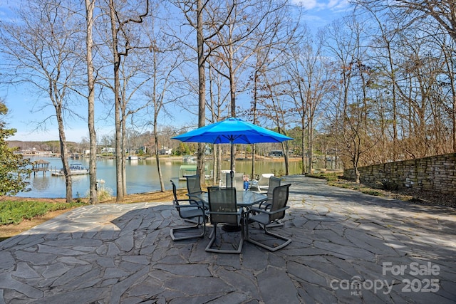 view of patio / terrace featuring a water view and outdoor dining space