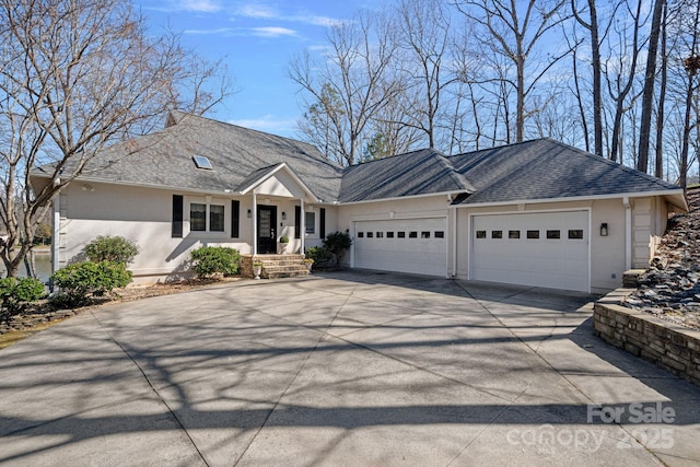 ranch-style house with a garage, roof with shingles, driveway, and stucco siding