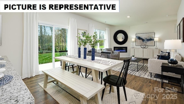 dining area with recessed lighting, dark wood finished floors, and a glass covered fireplace