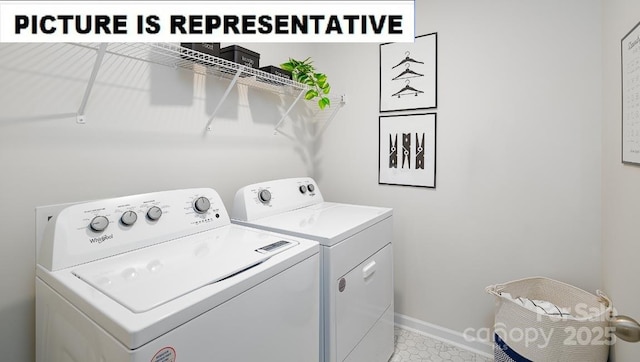 clothes washing area featuring laundry area, independent washer and dryer, and baseboards