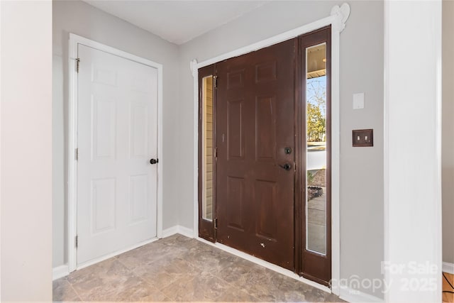 foyer entrance with baseboards