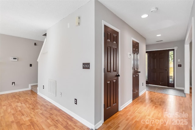 foyer featuring recessed lighting, baseboards, visible vents, and light wood finished floors