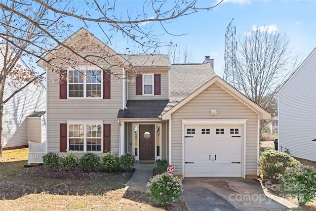 traditional-style home featuring a garage, driveway, a shingled roof, and a chimney