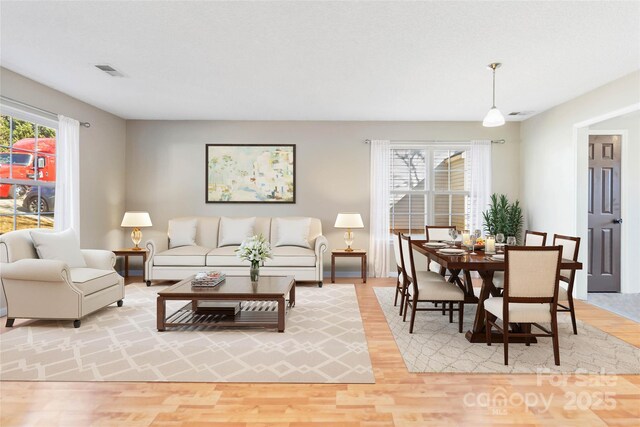 living area with light wood finished floors and visible vents