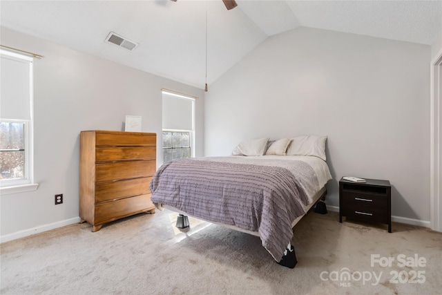 carpeted bedroom with visible vents, vaulted ceiling, baseboards, and ceiling fan