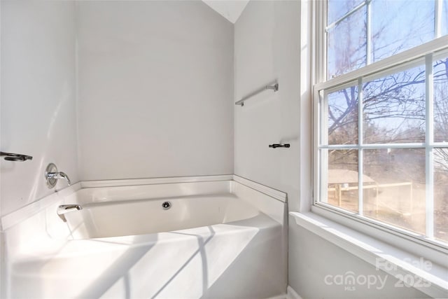 full bath featuring a tub to relax in