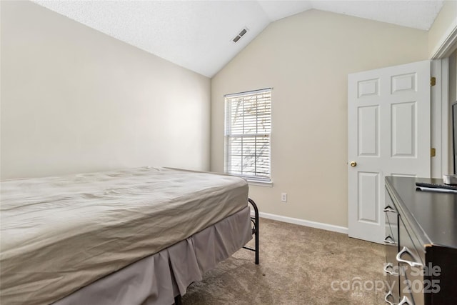 carpeted bedroom featuring baseboards, visible vents, and vaulted ceiling