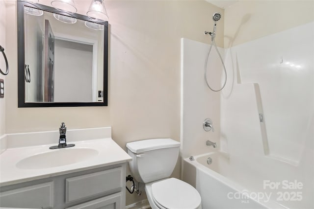 full bathroom with bathtub / shower combination, vanity, and toilet