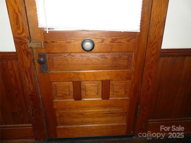 room details with a wainscoted wall and wooden walls