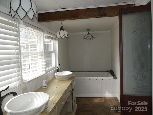 bathroom featuring double vanity, beamed ceiling, a sink, and a bath