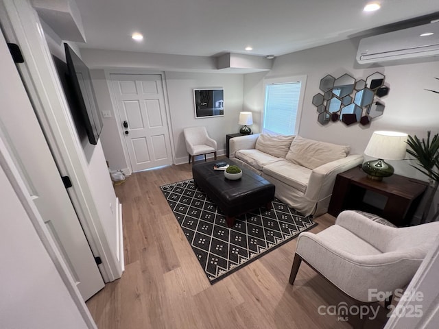 living area featuring light wood-style floors, recessed lighting, baseboards, and a wall mounted AC