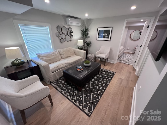 living room with baseboards, a wall mounted AC, wood finished floors, and recessed lighting