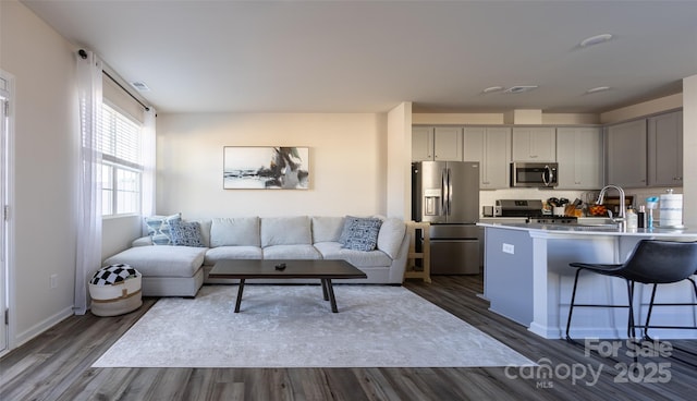 living area with visible vents, baseboards, and dark wood-style flooring