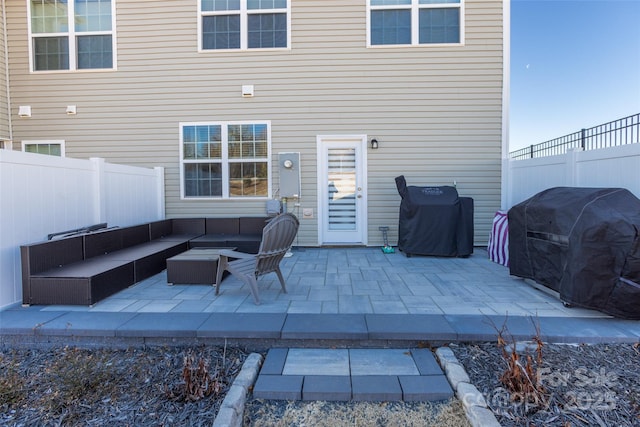 view of patio featuring area for grilling, outdoor lounge area, and a fenced backyard