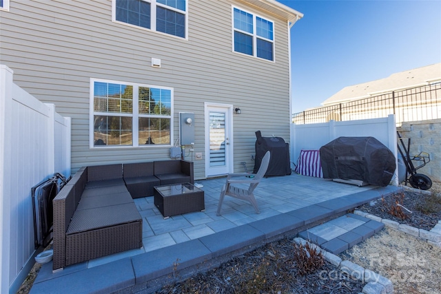 view of patio / terrace with a fenced backyard, an outdoor living space, and grilling area