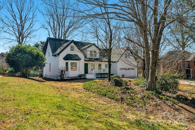 view of front of house with a garage and a front lawn