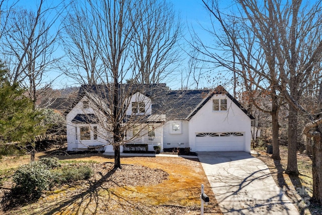 view of front of home with crawl space, roof with shingles, driveway, and stucco siding