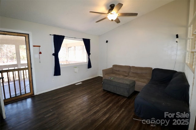 unfurnished living room with ceiling fan, visible vents, baseboards, vaulted ceiling, and dark wood-style floors