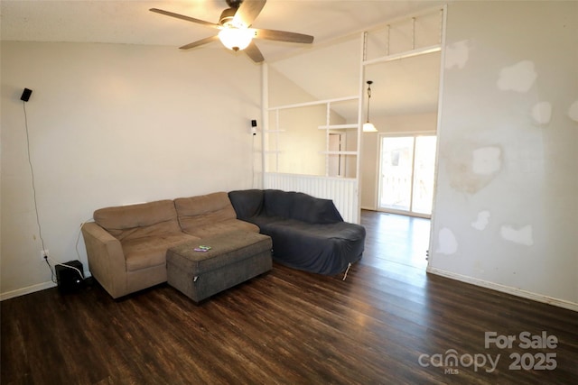 living area with lofted ceiling, dark wood finished floors, baseboards, and ceiling fan